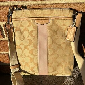 Coach beige swingpack crossbody purse with pink strip